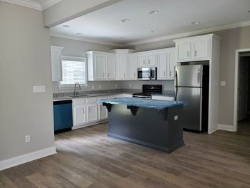 Albany house for rent - a kitchen with white cabinets and a blue counter top