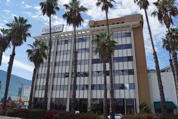 Long Beach apartment for rent - a tall building with palm trees in front of it