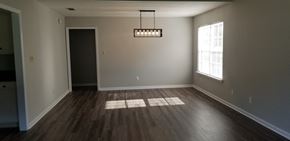 Leesburg house for rent - an empty living room with wooden floors and a window