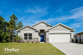 North Port house for rent - a house with a garage door and a lawn