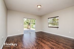 North Port house for rent - the living room and dining room with hardwood flooring and a sliding glass door