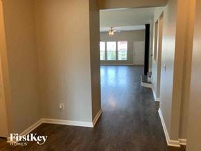 Moncks Corner house for rent - A room with wooden floors and white walls, with a doorway leading to another room.