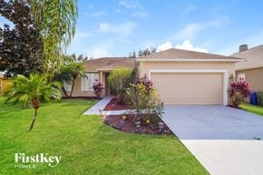 Winter Haven house for rent - a home with a driveway and a garage door