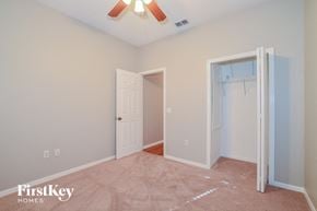 Winter Haven house for rent - a bedroom with a closet and a white door and a ceiling fan