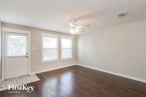 Haslet house for rent - A room with a white door and a fan on the ceiling.