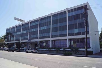 Long Beach apartment for rent - A large building with a lot of windows is on the corner of a street.