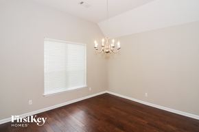 Arlington house for rent - A room with wooden floors and a chandelier.