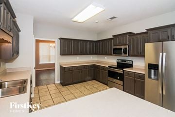 Arlington house for rent - A kitchen with brown cabinets and stainless steel appliances.