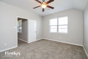 Crowley house for rent - the master bedroom has carpet and a ceiling fan