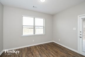 Crowley house for rent - the living room of an apartment with wood flooring and two windows