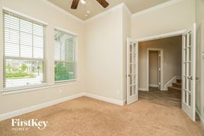 Arlington house for rent - a living room with a large window and a door to a hallway