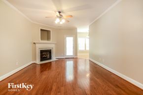 Mount Olive house for rent - a living room with a fireplace and a ceiling fan