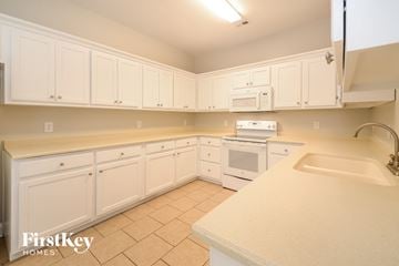 Mount Olive house for rent - a kitchen with white cabinets and appliances and a sink