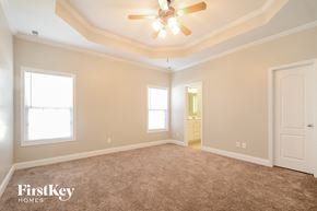 Mount Olive house for rent - a master bedroom with carpet and a ceiling fan
