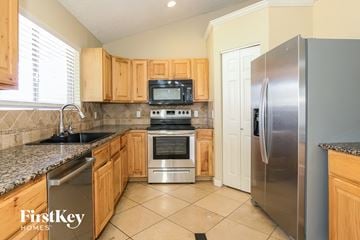 Glendale house for rent - A kitchen with wooden cabinets and a stainless steel refrigerator.