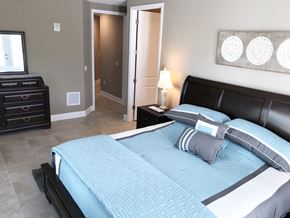 Bradenton house for rent - a bedroom with a bed and a dresser and a mirror