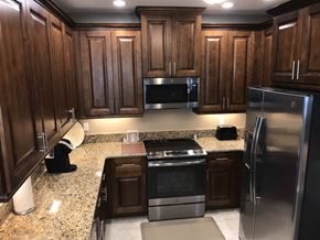 Bradenton house for rent - a kitchen with stainless steel appliances and granite counter tops