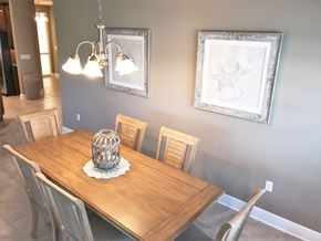 Bradenton house for rent - a dining room with a wooden table and a chandelier