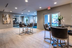 Morrisville apartment for rent - a clubhouse with a bar and chairs and a glass table