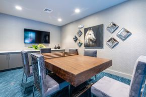 Morrisville apartment for rent - a dining room with a table and chairs and a tv on the wall