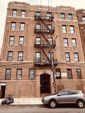Bronx apartment for rent - a car parked in front of a brick building