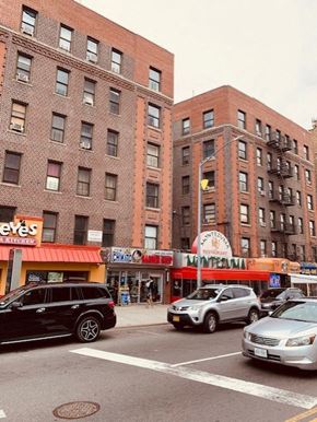 Bronx apartment for rent - a busy city street with cars and tall brick buildings