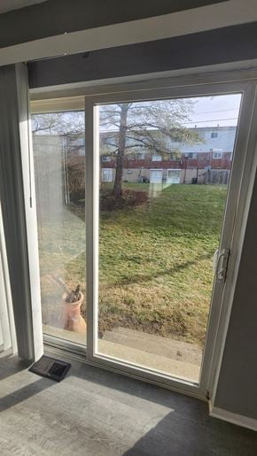 Cincinnati apartment for rent - A person is standing in a doorway looking out at a grassy area.