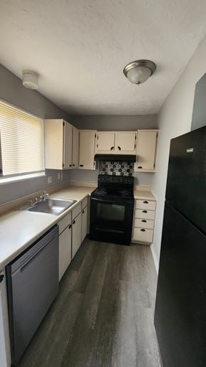 Cincinnati apartment for rent - A kitchen with black appliances and white cabinets.