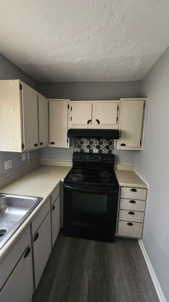 Cincinnati apartment for rent - A kitchen with a black stove top oven and white cabinets.