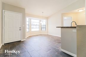 Deltona house for rent - an empty kitchen and living room with a white door