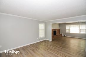Germantown house for rent - A room with wooden floors and a brick fireplace.