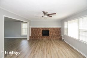 Germantown house for rent - A room with a brick fireplace and wooden floors.