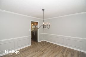 Germantown house for rent - A chandelier hangs over a white-walled room with wood flooring.