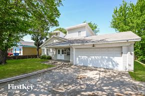 Dallas house for rent - a white house with a driveway and a white garage door