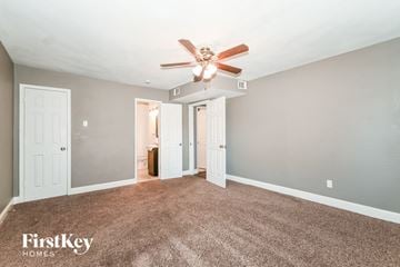 Dallas house for rent - a living room with carpet and a ceiling fan