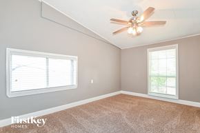 Dallas house for rent - an empty bedroom with a ceiling fan and a window