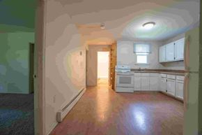 Gambrills apartment for rent - A kitchen with white cabinets and a refrigerator.