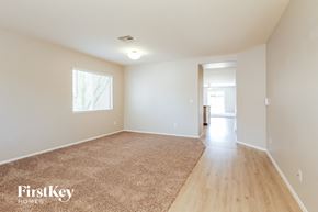 Youngtown house for rent - A room with a carpeted floor and a doorway leading to another room.