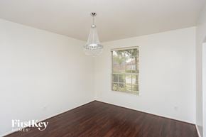 Garland house for rent - a bedroom with white walls and wood floors and a window