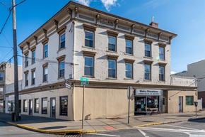 Hudson apartment for rent - a large white building on the corner of a street