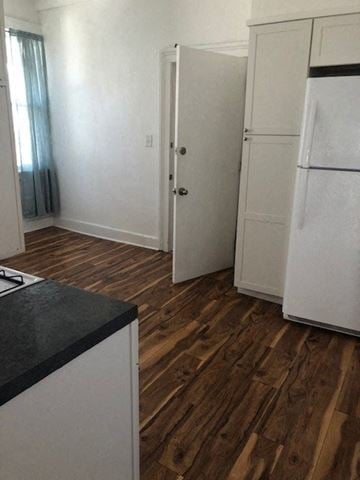 Hudson apartment for rent - a kitchen with white cabinets and a refrigerator