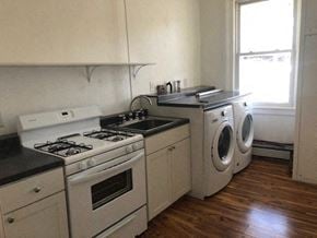 Hudson apartment for rent - a kitchen with white appliances and a washing machine