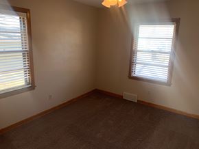 Fremont house for rent - A room with carpet flooring and two windows.