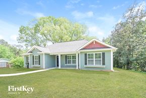 Austell house for rent - a blue house with a yard and a red roof