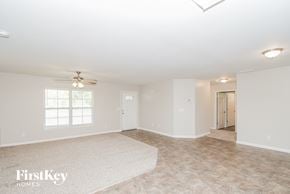 Austell house for rent - a empty living room with a ceiling fan and a rug