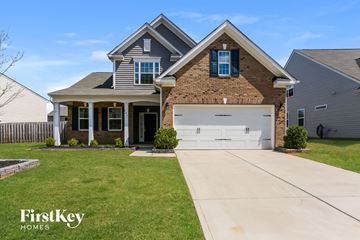 Mount Holly house for rent - a house with a white garage door in front of a lawn
