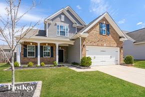 Mount Holly house for rent - a house with a white garage door in front of a lawn