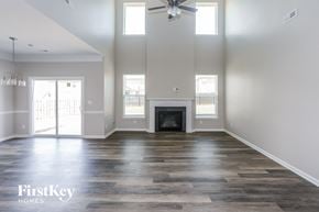 Mount Holly house for rent - an empty living room with a fireplace and a ceiling fan