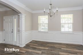 Mount Holly house for rent - a dining room with white wainscoting and a chandelier