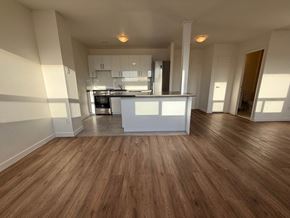 Toronto apartment for rent - A kitchen with wooden floors and white walls.